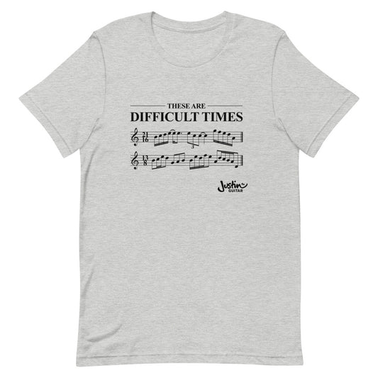 Grey shirt with 'These are difficult times' and music notation.