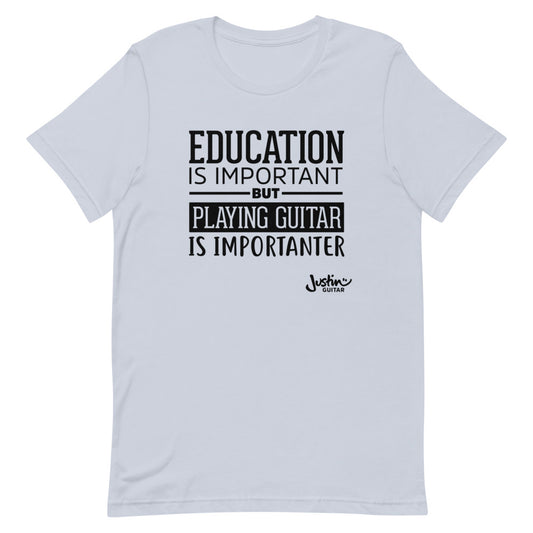 Light blue tshirt that says 'Education is important, but playing guitar is importanter'