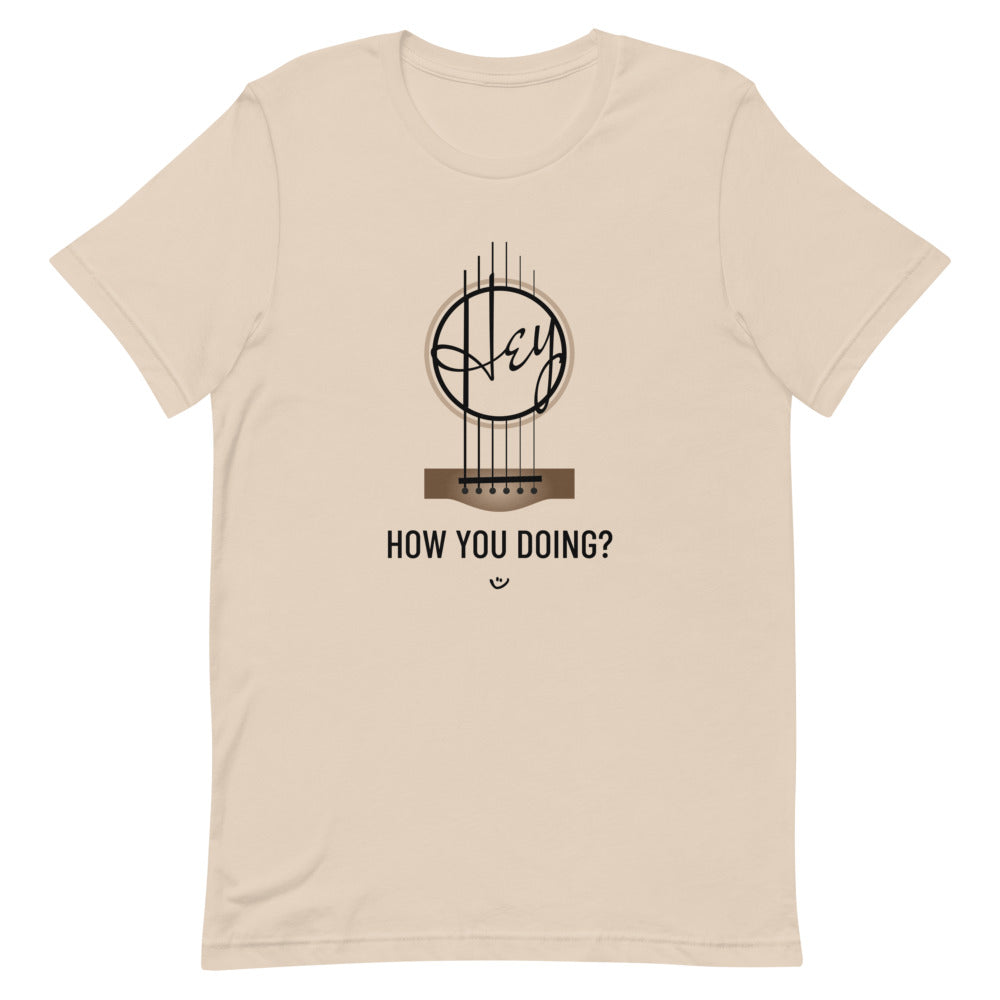 Beige tshirt with 'Hey, How you doing? guitar design.