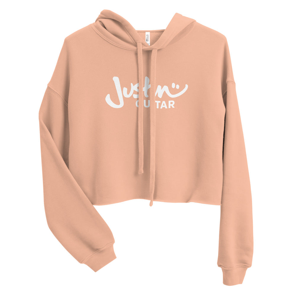 Peach cropped hoodie with JustinGuitar logo.